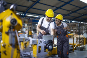 Industrial employees working together in factory production line.